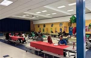  People in a cafeteria for a program